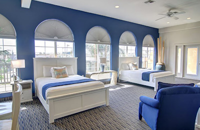 2 Queen Bed Suite featuring elegant blue walls, cozy beds, and stylish furniture at Alister Square Inn