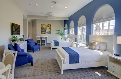 Spacious 2 Queen Bed Suite at Alister Square Inn with comfortable seating and natural light