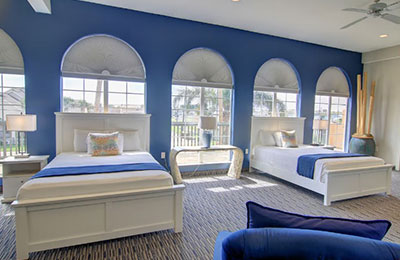 Elegant 2 Queen Bed Suite with cozy beds, large windows, and vibrant furnishings at Alister Square Inn