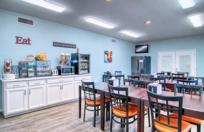 Bright breakfast room at Alister Square Inn with modern seating and self-serve stations