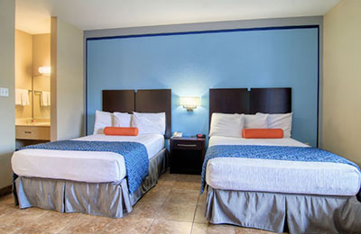 Spacious 2 Queen Bed Standard Room at Alister Square Inn with soft lighting and tiled flooring