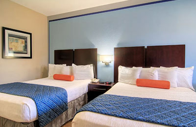 2 Queen Bed Room at Alister Square Inn featuring warm lighting, tiled floors, and modern amenities